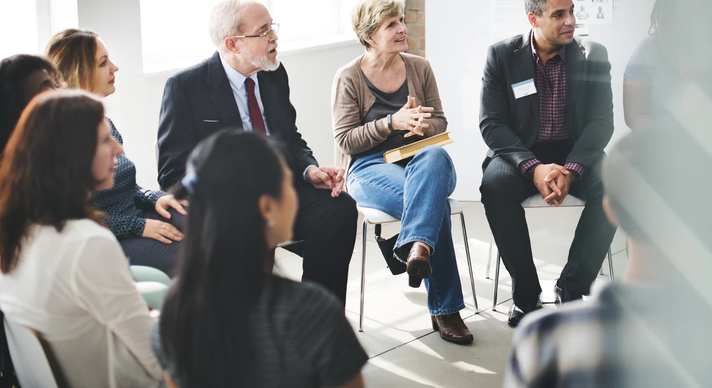 Team members participating in a leadership workshop exercise